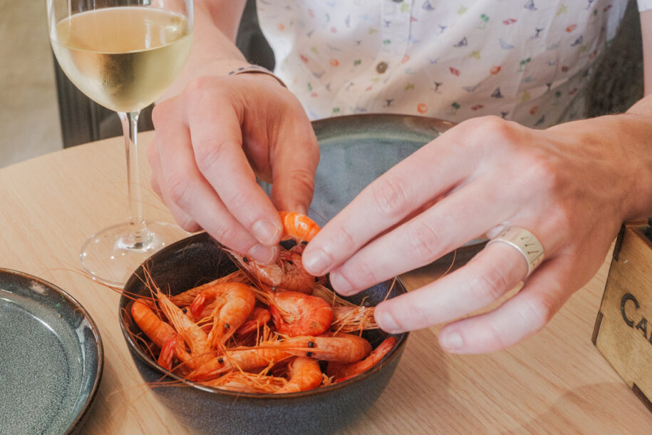 Hand eating shrimp from the coast of Viana do Castelo